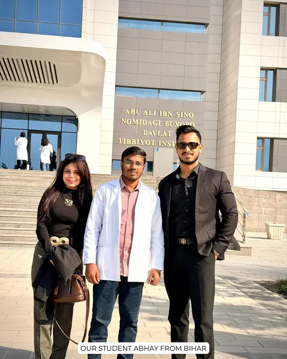 Abhay in a white coat with Scholars Abroad representatives outside Bukhara State Medical Institute