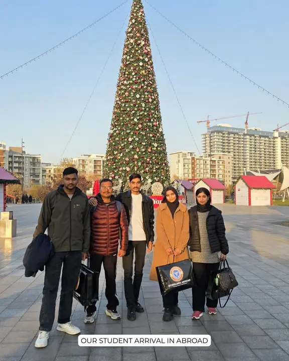 Five students with Scholars Abroad bags posing together in a plaza after arriving abroad