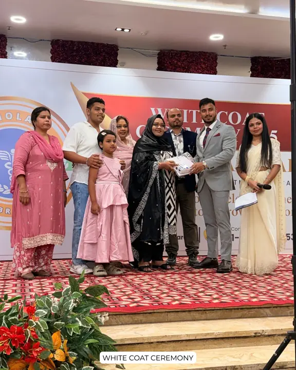 A student and family members at a Scholars Abroad white coat ceremony