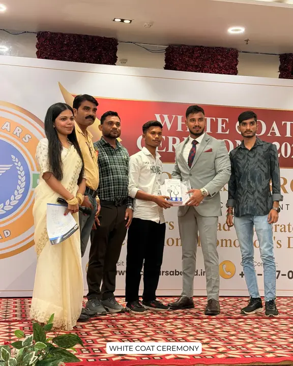 A student and family with Scholars Abroad representatives at a white coat ceremony