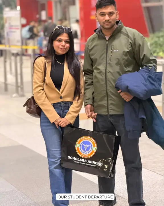 A student with a Scholars Abroad representative at an airport before departure