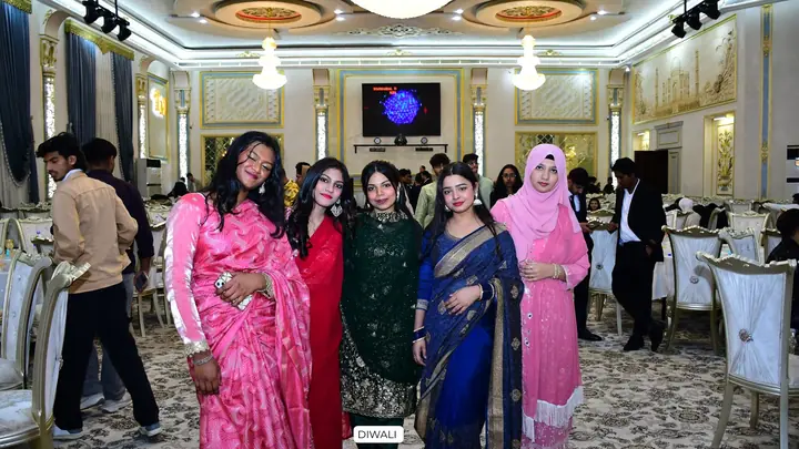 Five students posing together in festive clothing at a Diwali celebration
