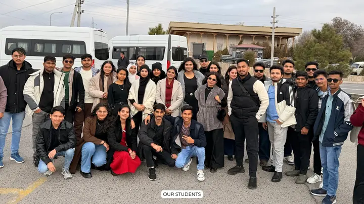 A group of Scholars Abroad students outdoors beside minibuses