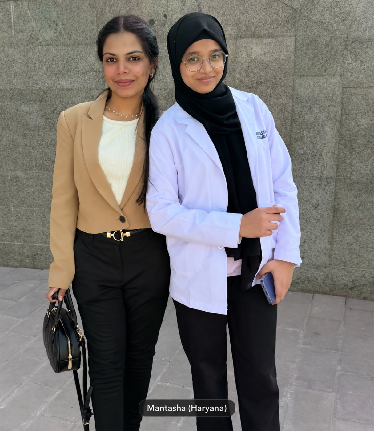 Mantasha in a white coat with a Scholars Abroad team member in Uzbekistan.