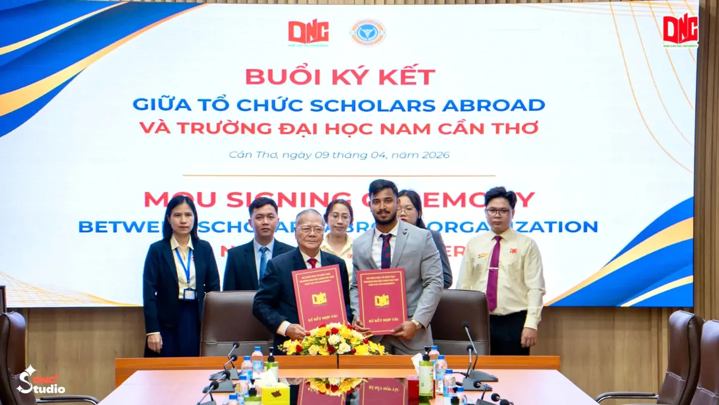Scholars Abroad representatives and Nam Can Tho University officials holding MoU folders at the signing ceremony