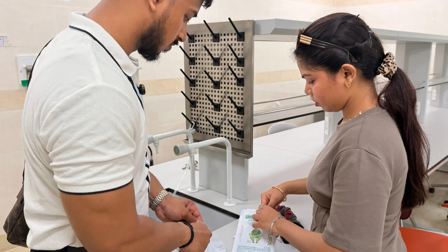 Scholars Abroad team members observing laboratory supplies during the university visit