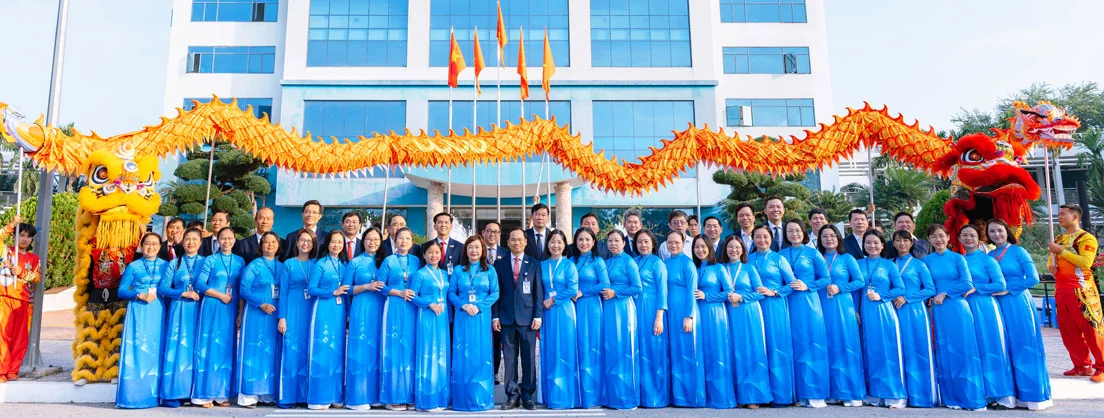Group at a cultural event outside a CTUMP campus building with dragon and lion performers