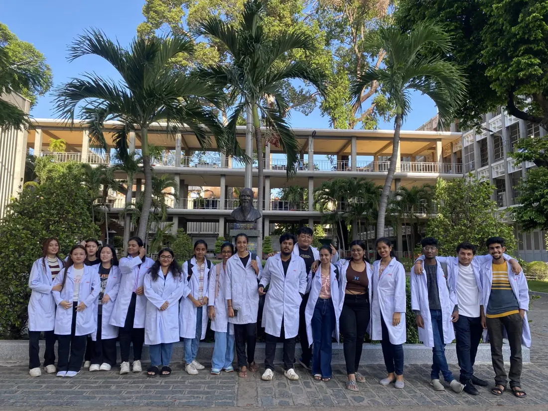 Students wearing medical coats in a group photograph published by Hong Bang International University